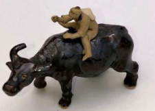 Ceramic Figure Man Ridding on Buffalo